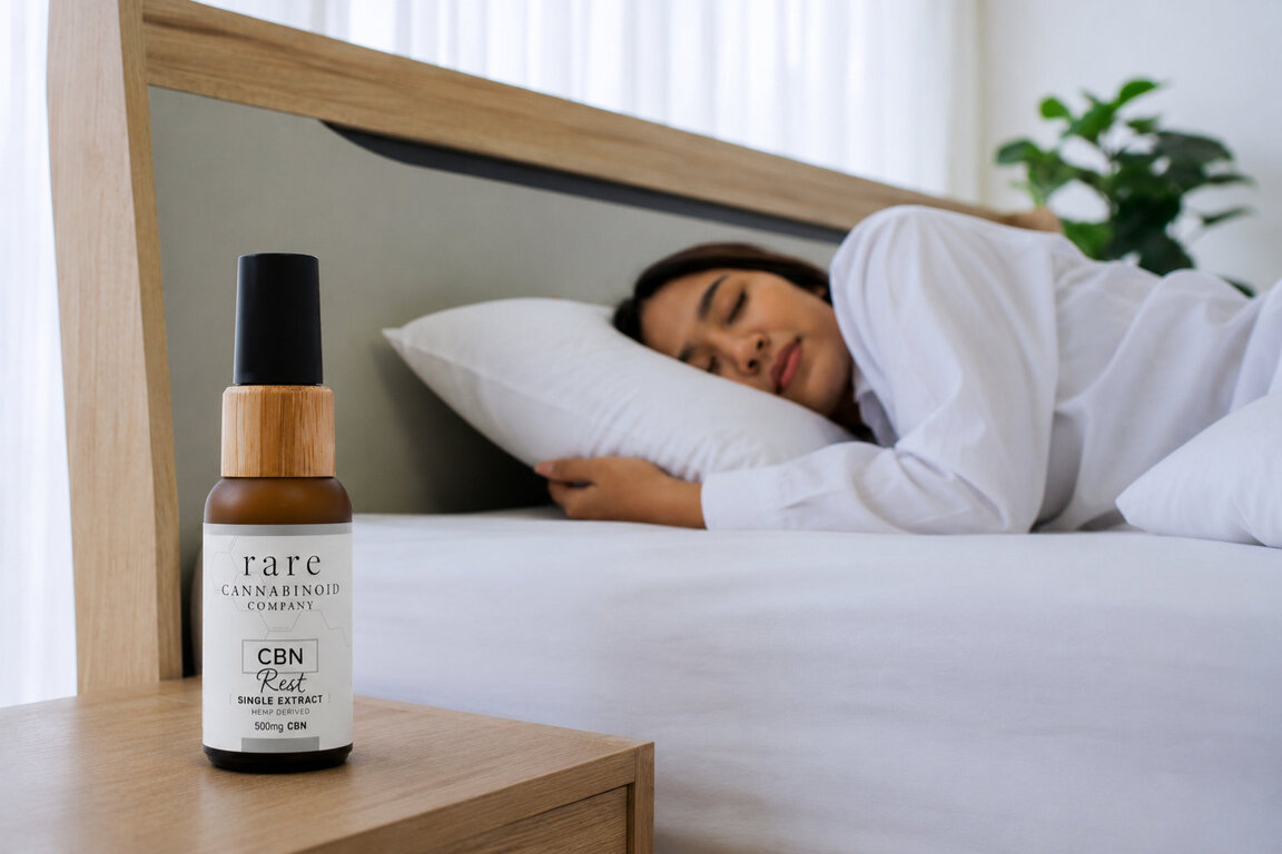 CBN Rest Oil on the nightstand of a woman sleeping peacefully.