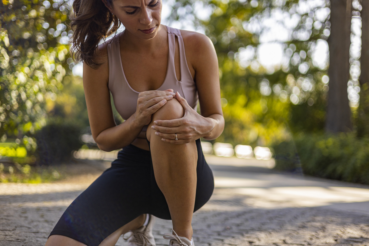 Woman with a sore knee representing CBG for relief of everyday aches and stiffness.